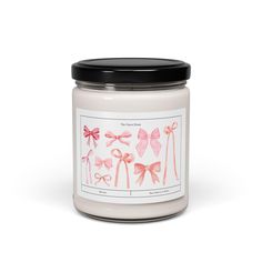 a white candle with pink bows on it