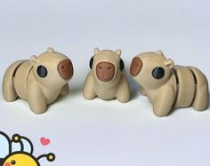 three wooden toy animals sitting next to each other