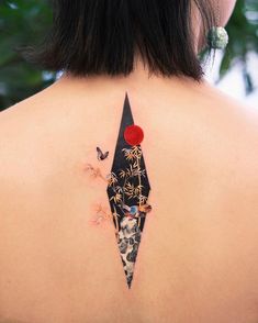 the back of a woman's neck with tattoos on it