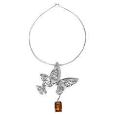 Intention: Flying High Design: Three butterflies in flight unite to form the dramatic pendant drop on this sterling silver collar. Providing encouragement to BELIEVE in yourself, this arch of butterflies is accented by a dramatic citrine drop. Style Suggestions: See how much fun going casual can be with this sexy collar and pendant Particulars: sterling silver citrine collar is 5 5/8" length, 5 1/4" width pendant is 3 3/4" length, 3 1/4" width Handcrafted in Oakland, CA. Butterflies In Flight, Three Butterflies, Flying High, Higher Design, Believe In Yourself, Butterfly Pendant, In Flight, Citrine, Metal Working