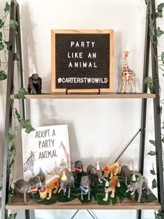 a shelf filled with figurines on top of a wooden floor next to a sign