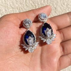 Sapphire earrings featuring semi precious blue stone and cz diamonds in teardrop shape. Ideal jewelry to pair with your bridal wedding gown or any special occasion outfit. These LUXURY Earrings surely elevate your look. Perfect gift for her. *𝐏𝐑𝐎𝐃𝐔𝐂𝐓 𝐃𝐄𝐓𝐀𝐈𝐋* * 𝐌𝐚𝐭𝐞𝐫𝐢𝐚𝐥: Brass * 𝐏𝐥𝐚𝐭𝐢𝐧𝐠: White Rhodium Plated * 𝐒𝐭𝐨𝐧𝐞: AAA-quality CZ Pink Diamond & Sapphire. *𝐃𝐈𝐌𝐄𝐍𝐒𝐈𝐎𝐍𝐒* * 𝐖𝐞𝐢𝐠𝐡𝐭: 7 gm each * 𝐋𝐞𝐧𝐠𝐭𝐡: 3.7 cm * 𝐖𝐢𝐝𝐭𝐡: 2 cm * 𝐂𝐥𝐨𝐬𝐮𝐫𝐞: Sapphire Diamond Earrings, Bride Wedding Gift, Occasion Outfit, Sapphire And Diamond Earrings, Earrings Luxury, Wedding Gifts For Bride, Luxury Earrings, Special Occasion Outfits, Sapphire Earrings