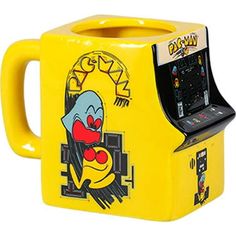 a yellow arcade machine with an angry clown face on it's front and sides