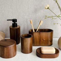 wooden bathroom accessories including soap, toothbrush holder and soap dispenser