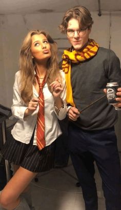 a man and woman dressed in harry potter costumes posing for the camera with a coffee mug