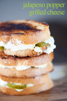 three grilled cheese sandwiches stacked on top of each other with jalapeno peppers