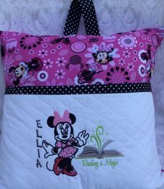 a pink and white pillow with minnie mouse on it