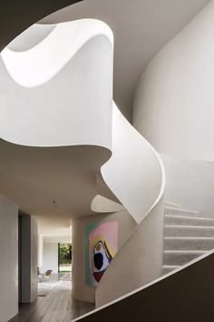 the interior of a modern house with white walls and stairs