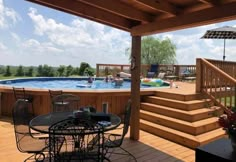 an above ground pool surrounded by wooden decking