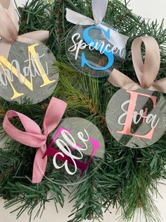 christmas ornaments with ribbons and bows on them