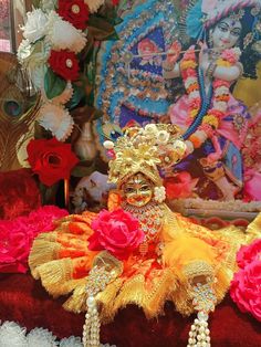 an elaborately decorated statue with flowers on display