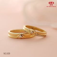 two gold wedding rings with diamond accents on a pink background, one is for him and her