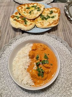 two plates of food on a table with bread