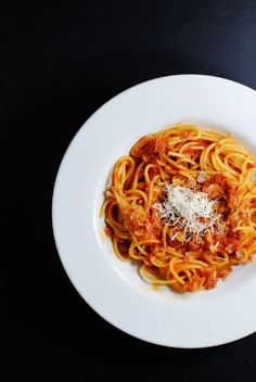 a white plate topped with spaghetti and sauce