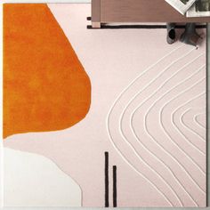 an orange and white rug on top of a wooden table