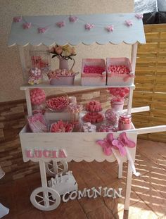 a display case filled with lots of pink and white candy bars on top of a wooden table