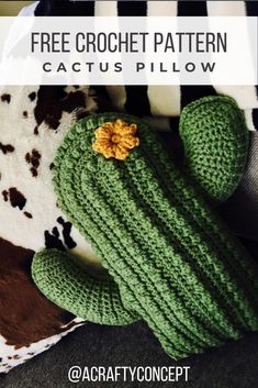 a green crochet cactus pillow sitting on top of a cow skin rug with the text free crochet pattern cactus pillow