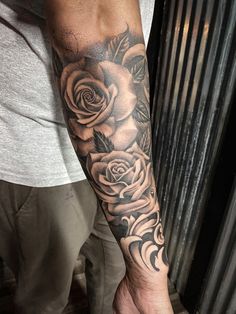 a man with a rose tattoo on his arm