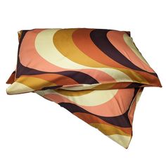 an orange and brown pillow on top of each other