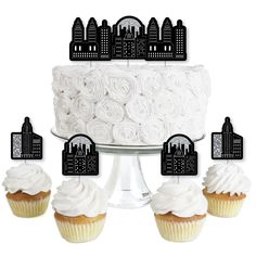 cupcake toppers with city skyline silhouettes on them and white frosted cupcakes