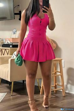 a woman in a pink dress taking a selfie