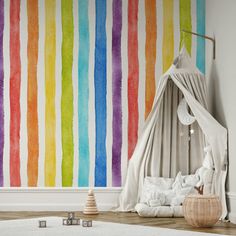 a room with a rainbow painted wall and white rugs on the floor next to a bed