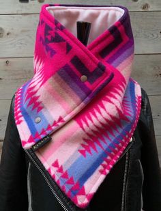 a woman wearing a pink and blue scarf