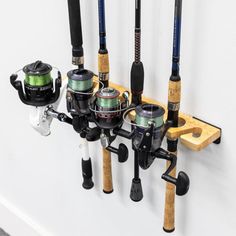 there are many fishing rods and reels hanging on the wall