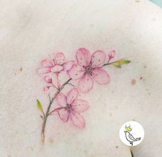 the back of a woman's breast with pink flowers on it