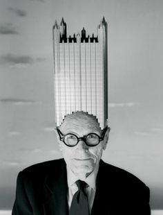 an old man in a suit and tie with a building on top of his head