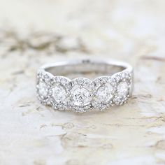 a diamond ring sitting on top of a marble surface