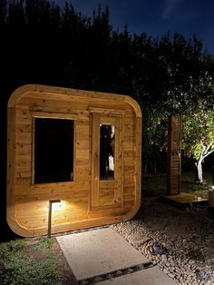 an outdoor sauna is lit up at night