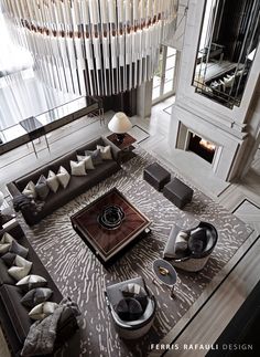 an aerial view of a living room with couches, tables and fireplace in the center