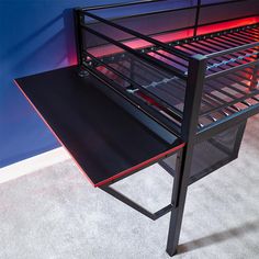 a metal bed frame sitting on top of a carpeted floor next to a blue wall