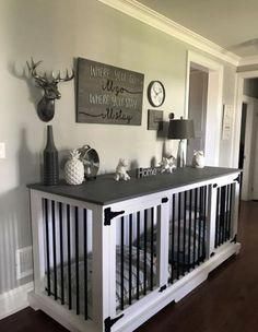 a baby crib in the middle of a room with pictures on the wall above it