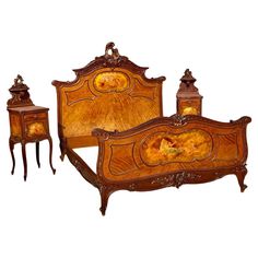 an antique wooden bed with two night stands