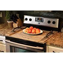 a bowl of fruit on a cutting board in front of an oven