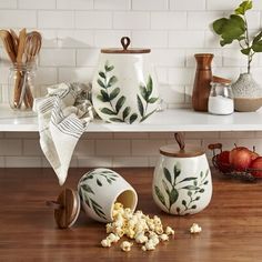 the kitchen counter is covered with dishes and utensils, such as kettles