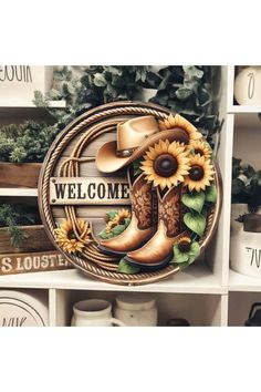 a cowboy themed welcome sign with sunflowers and boots in the center on a shelf