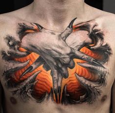 a man's chest with an orange and black tattoo design on his chest area