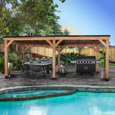 an outdoor kitchen and grill area next to a pool