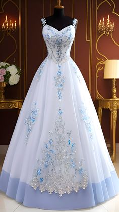 a white and blue wedding gown on display in a room with chandelier lights