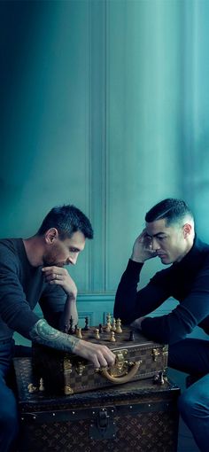 two men are playing chess in an old suitcase