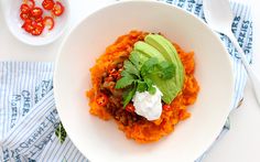 a white bowl filled with food on top of a table