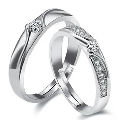 two white gold wedding rings with diamonds on each side and one diamond in the middle