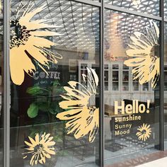 the window is decorated with yellow flowers and words that say, hello sunshine modoo