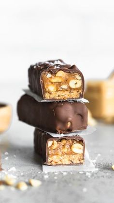 three chocolate bars stacked on top of each other with nuts in the middle and one bar cut in half