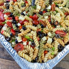 a large metal pan filled with pasta salad