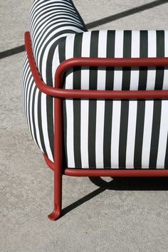 a black and white striped chair sitting on concrete