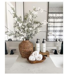 a basket with flowers and towels on a bathroom counter